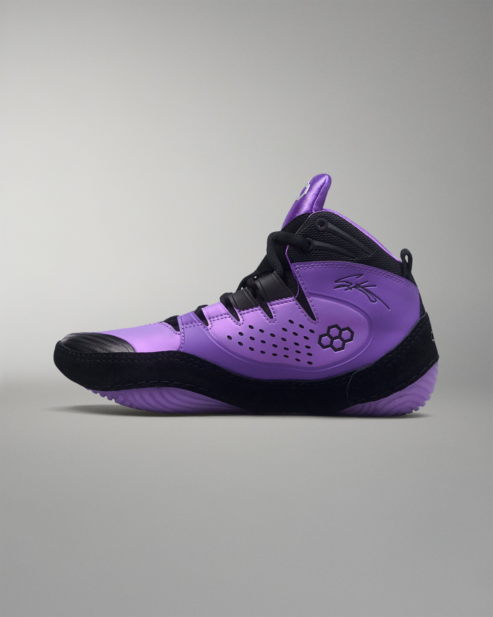 Purple and black wrestling shoe on a gray background
