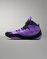 Purple and black wrestling shoe on a gray background