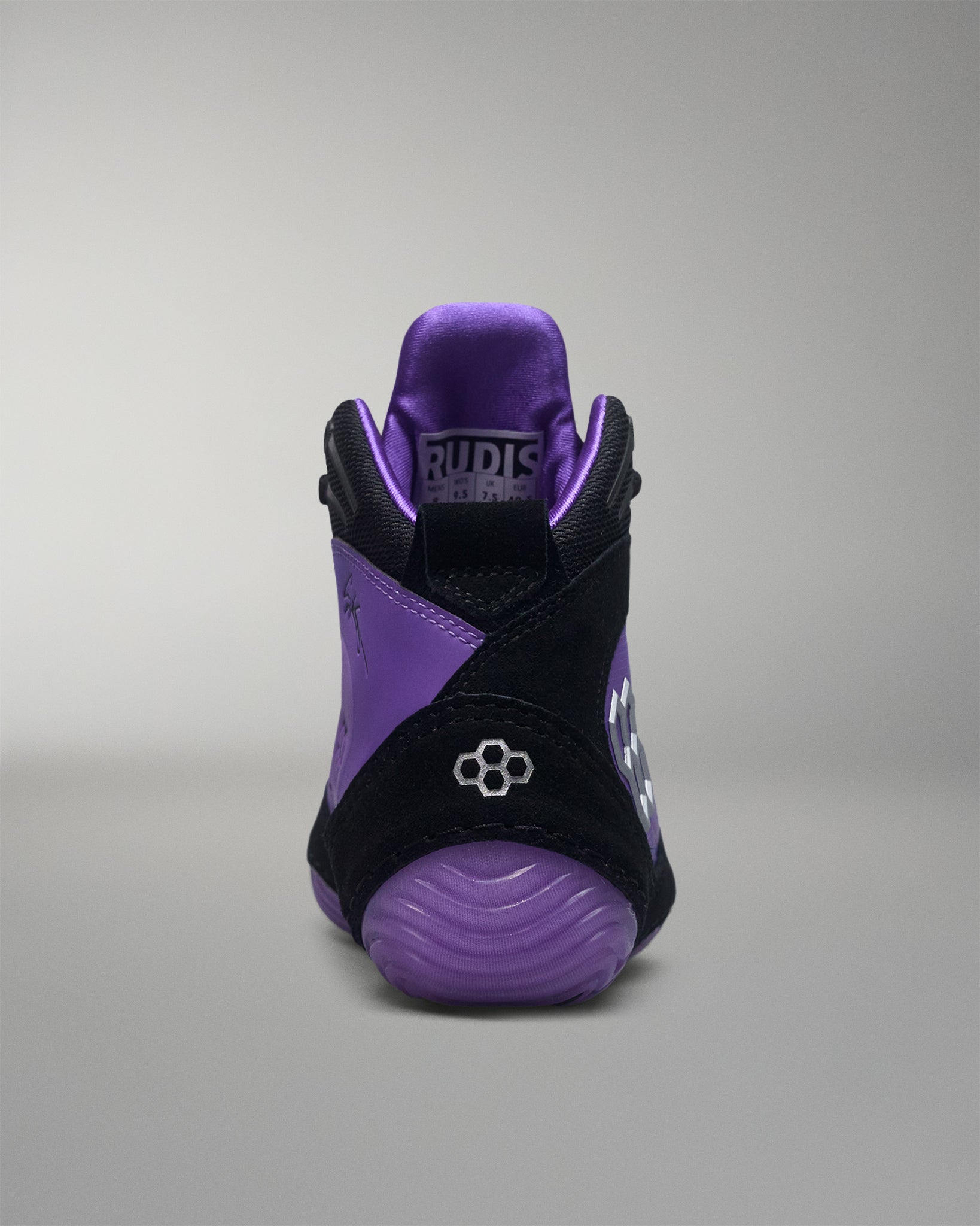 Purple and black wrestling shoe on a gray background