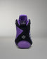 Purple and black wrestling shoe on a gray background