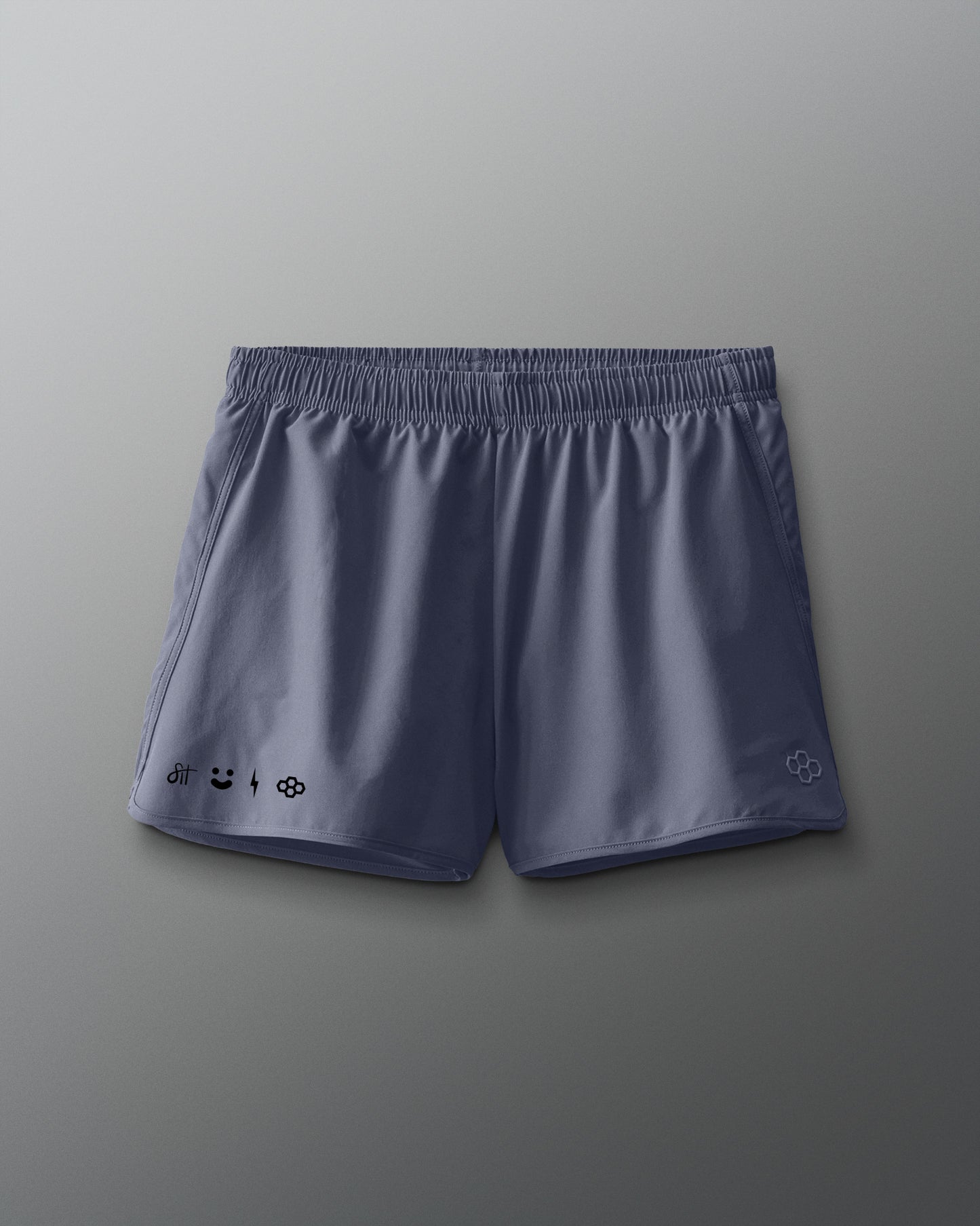 Blue athletic shorts with brand logos on a gray background