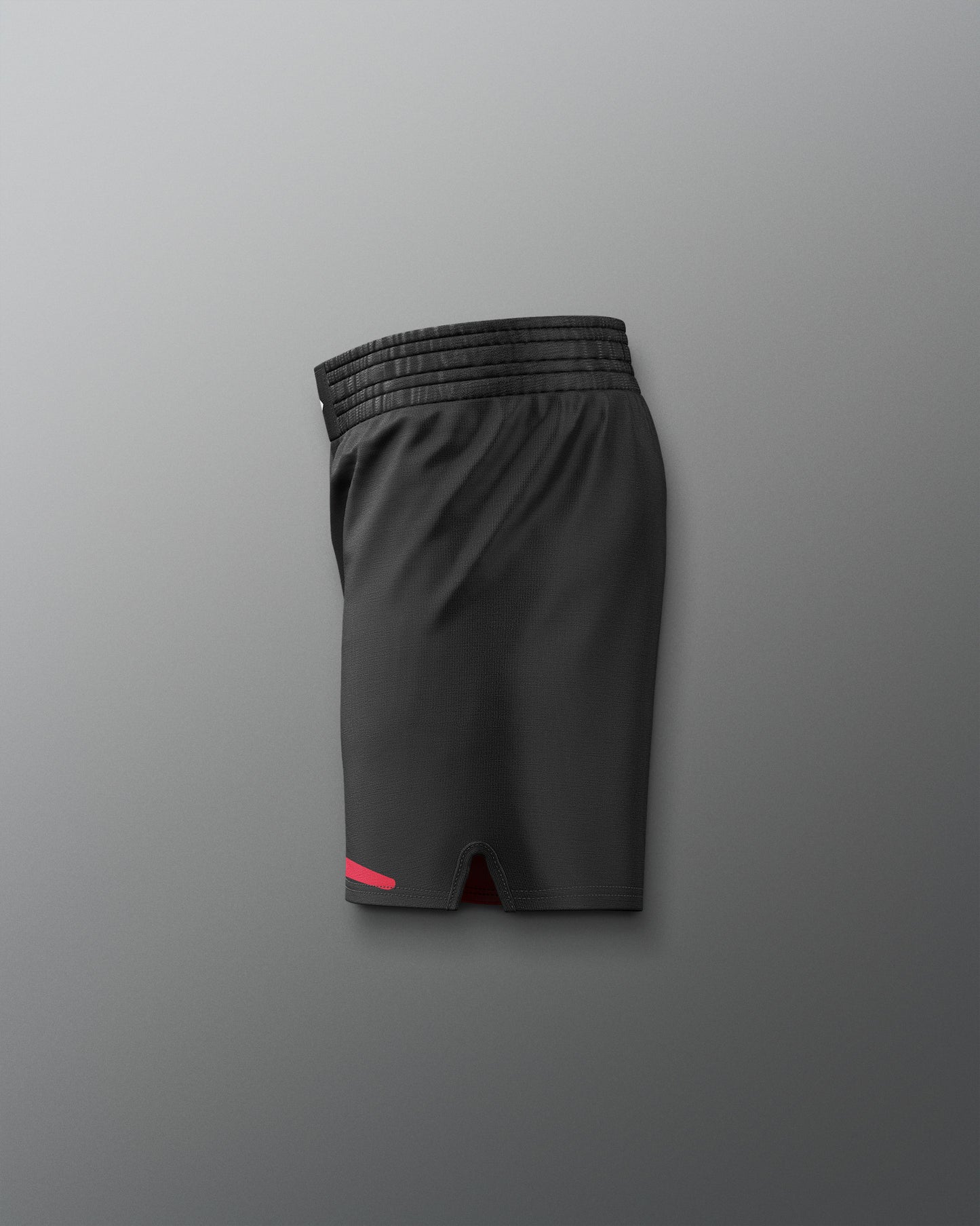Black athletic shorts with a red accent on a gray background