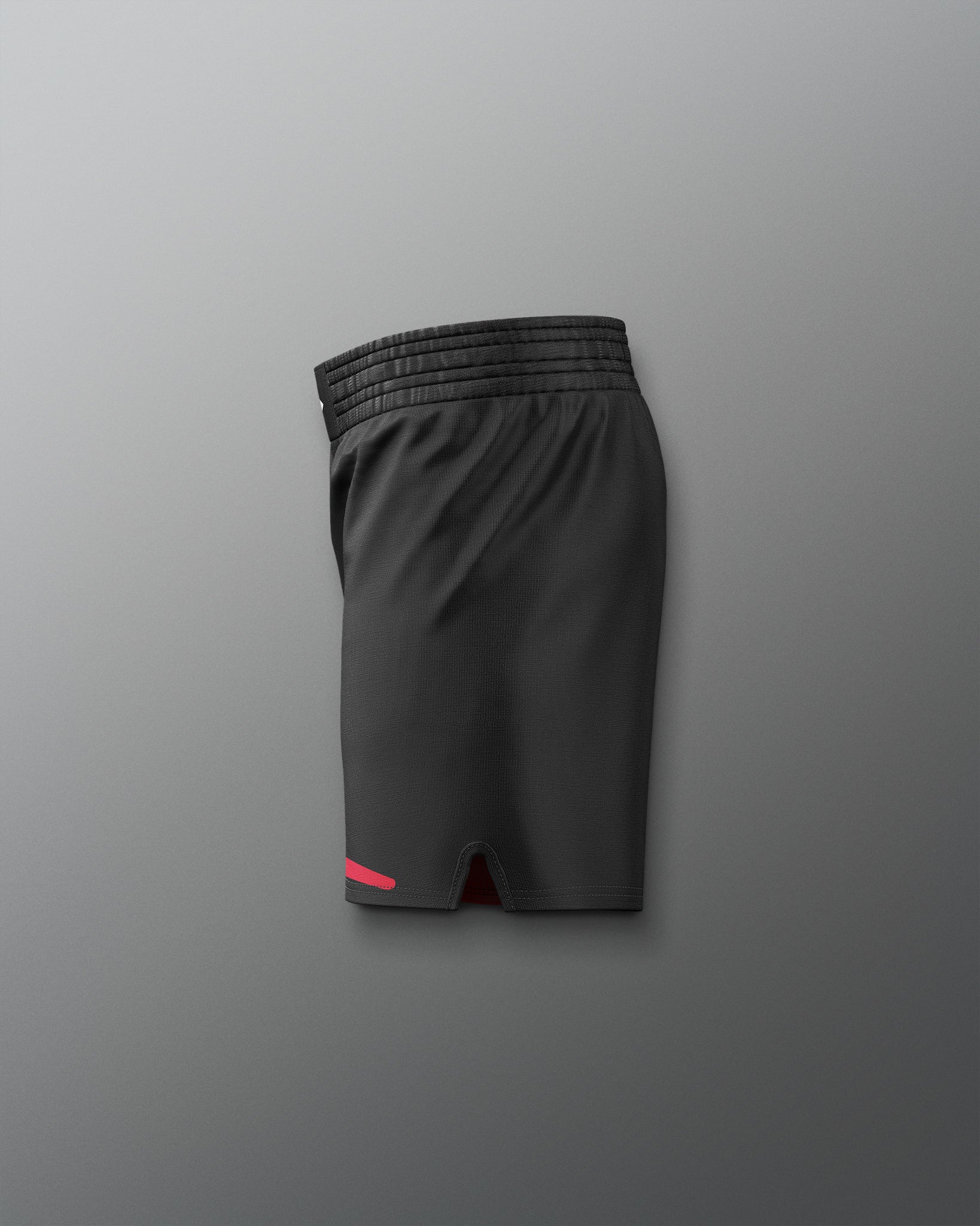 Black athletic shorts with a red accent on a gray background