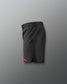 Black athletic shorts with a red accent on a gray background