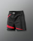 Black athletic shorts with red accents on a gray background