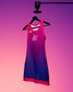 Pink and blue sports outfit on a hanger against a gradient purple to pink background