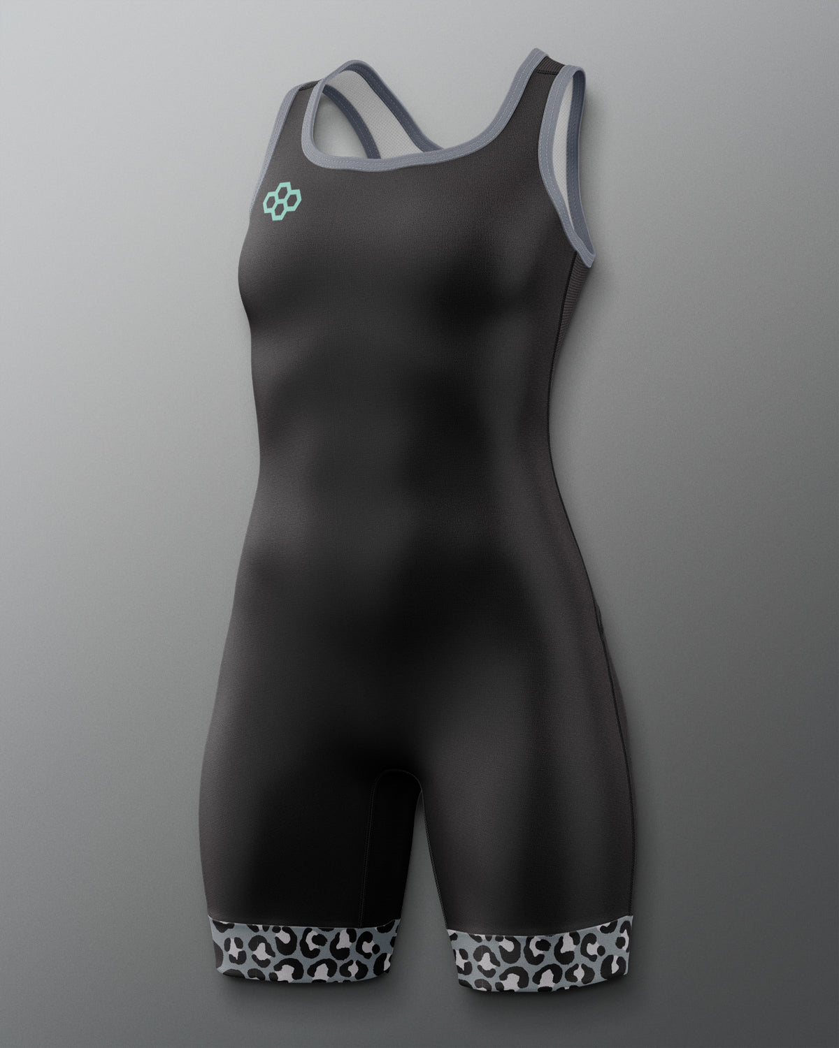 A black one-piece athletic wrestling singlet with gray trim on the straps and neckline, featuring a small mint green logo on the left chest and a black-and-white patterned hem at the legs, shown against a gray gradient background.