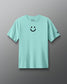 Light blue t-shirt with a smiley face design on a gray background