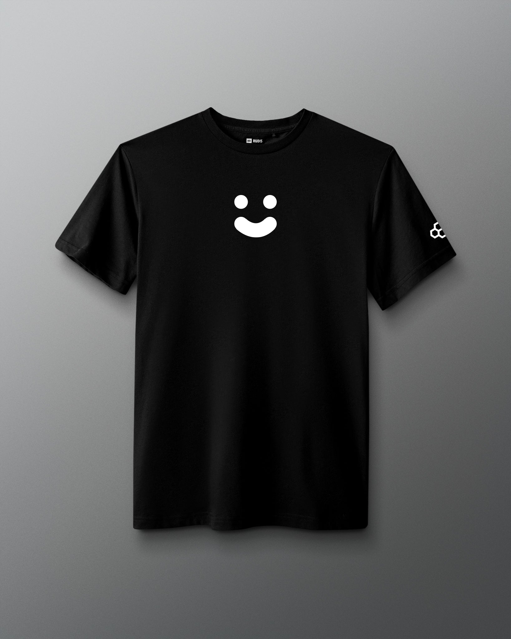 A black short-sleeve crewneck t-shirt featuring a white minimalist smiley face graphic on the center chest and a small white geometric logo on the left sleeve, displayed against a neutral gray background.