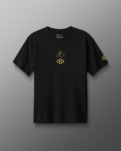 Black RUDIS JB Gold Heavyweight T-Shirt shown from the front, featuring gold Jordan Burroughs signature and RUDIS graphics on the chest with a coordinating gold RUDIS logo on the sleeve.
