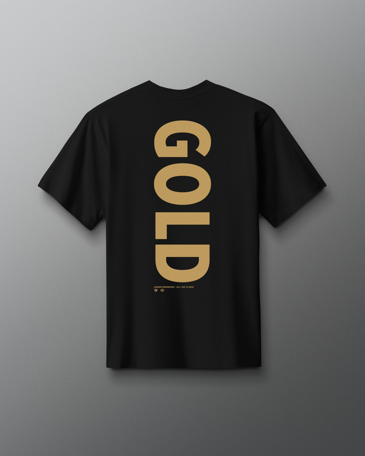 Back view of the black RUDIS JB Gold Heavyweight T-Shirt featuring oversized vertical gold “GOLD” lettering with Jordan Burroughs and RUDIS details beneath the graphic.