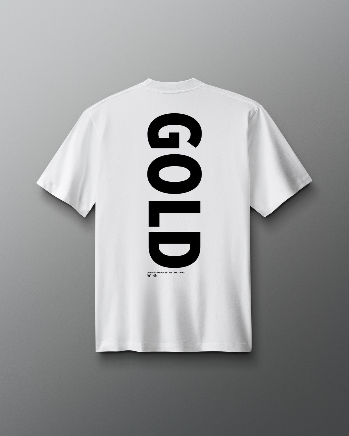 Back view of the white RUDIS JB Gold Heavyweight T-Shirt featuring oversized vertical black “GOLD” lettering with Jordan Burroughs and RUDIS details beneath the graphic.
