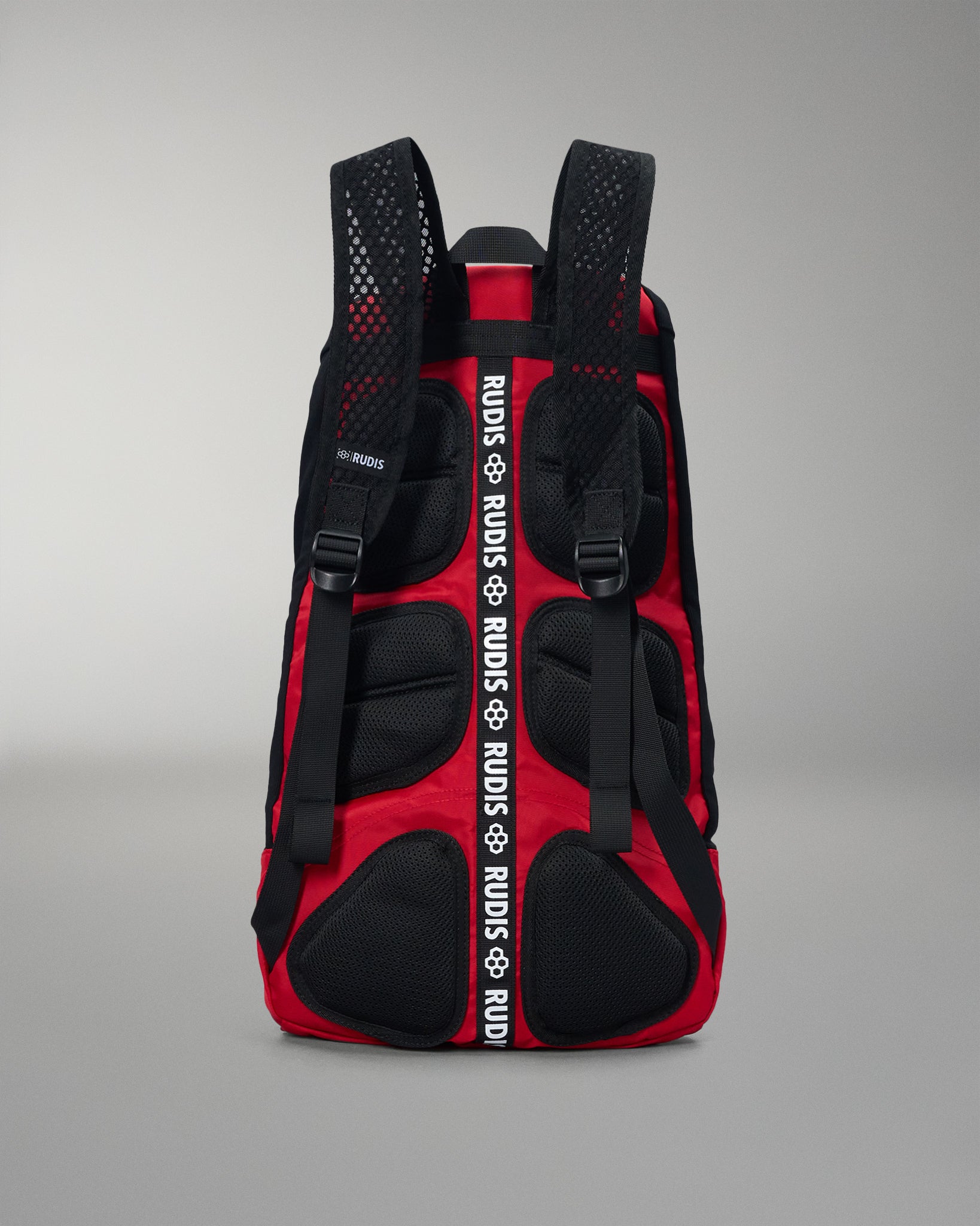 Red and black backpack with visible branding on a gray background