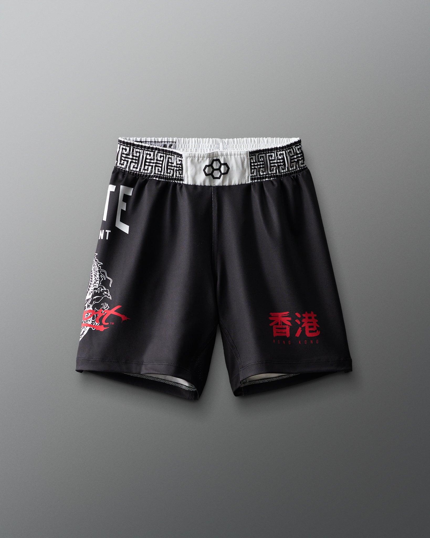 Black shorts with red text and white waistband on a gray background