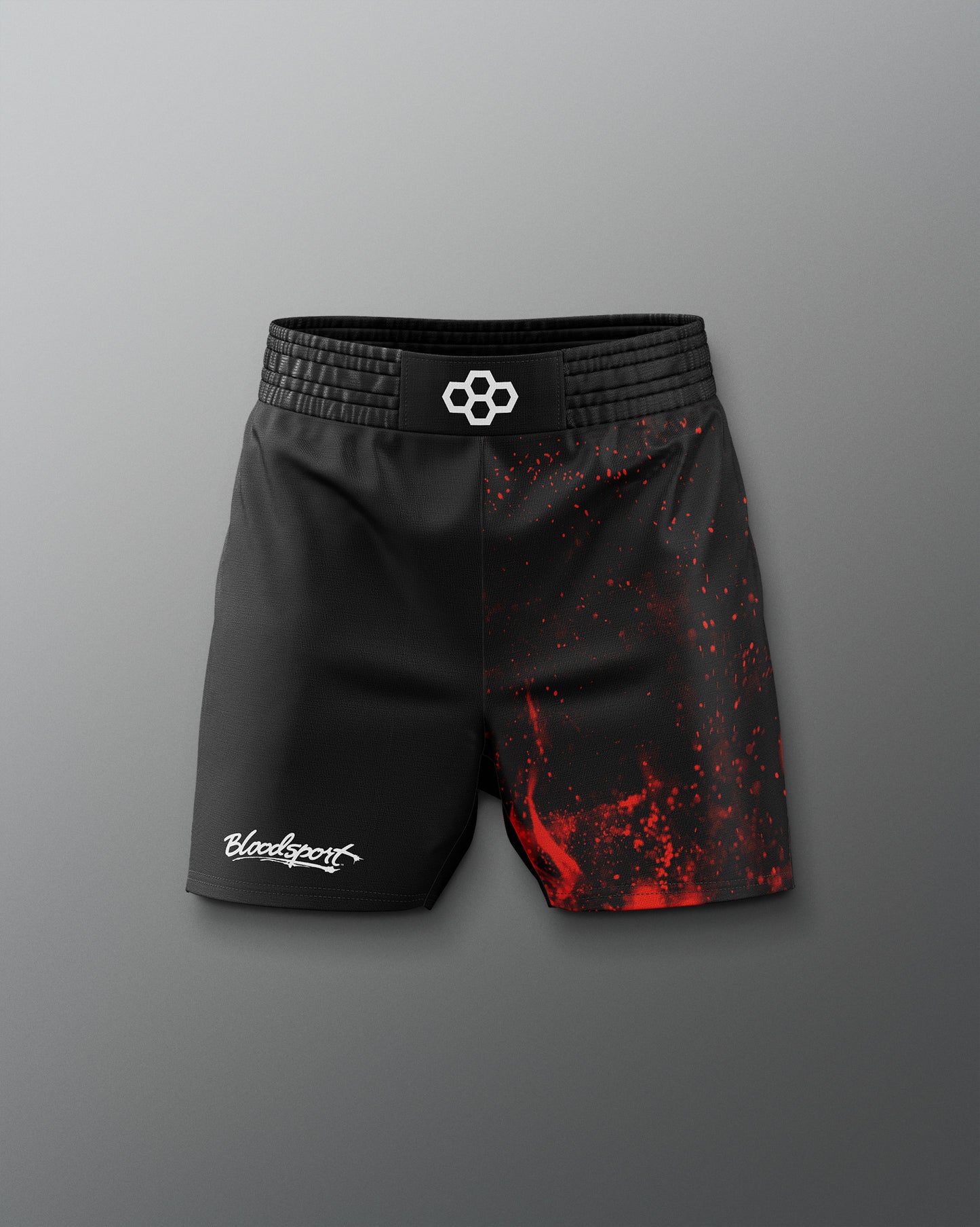 Black athletic shorts with red splatter design on a gray background