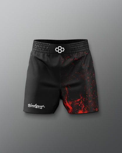 Black athletic shorts with red splatter design on a gray background