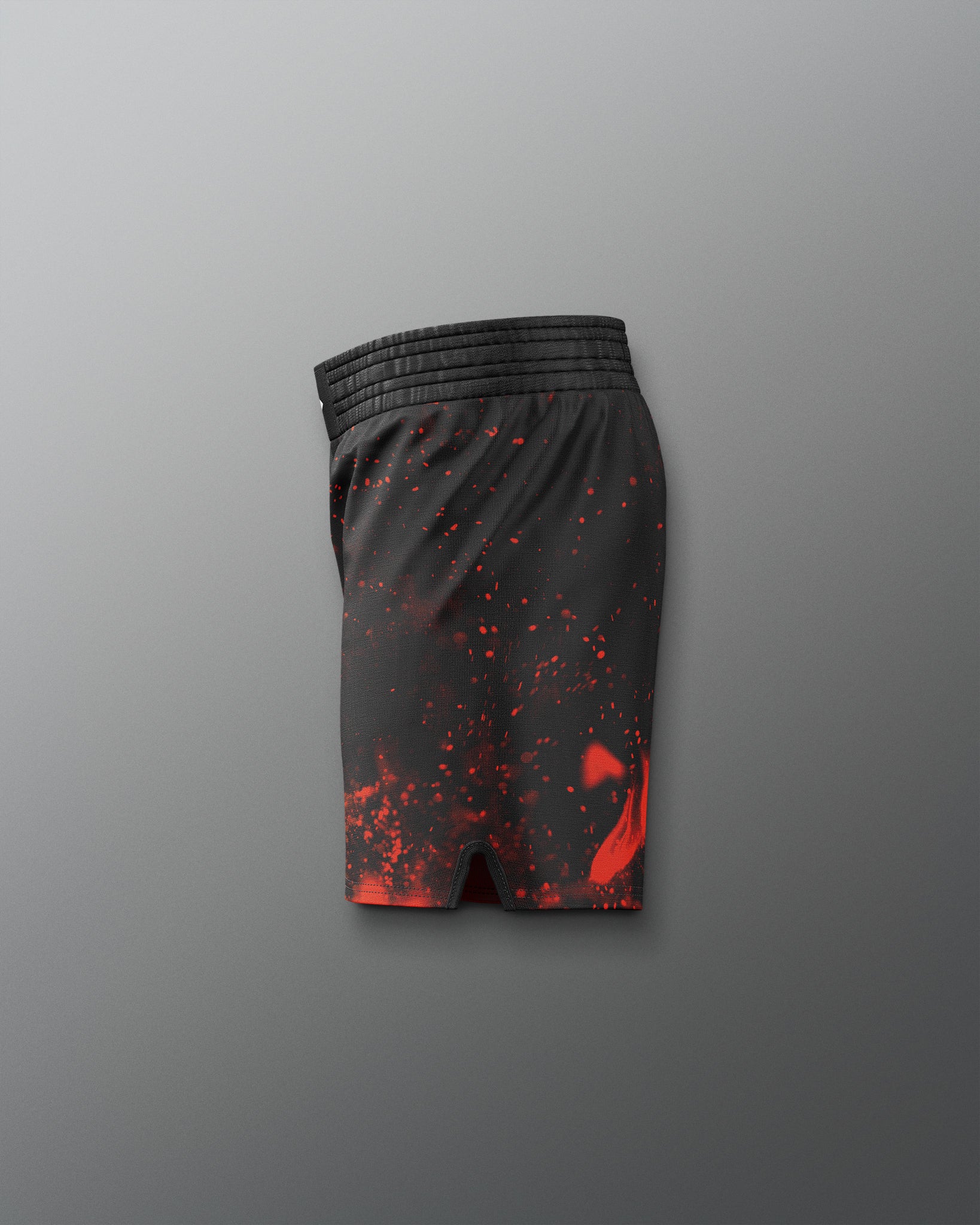 Black shorts with red splatter pattern on a gray background