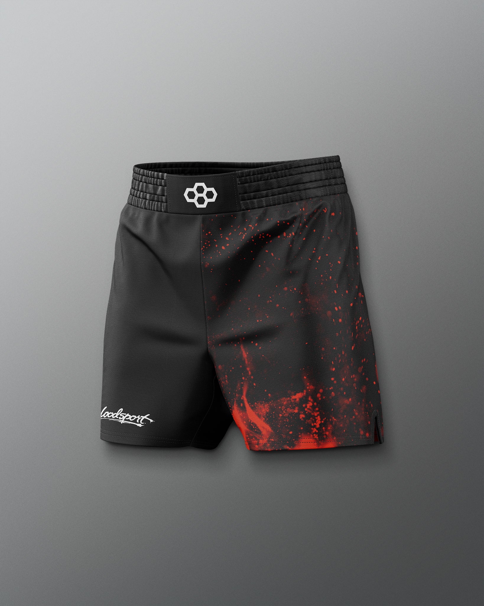Black athletic shorts with red splatter design on a gray background