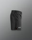 Black shorts with a brand logo on a gray background