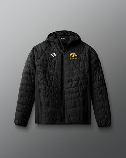 Black quilted jacket with logos on a gray background
