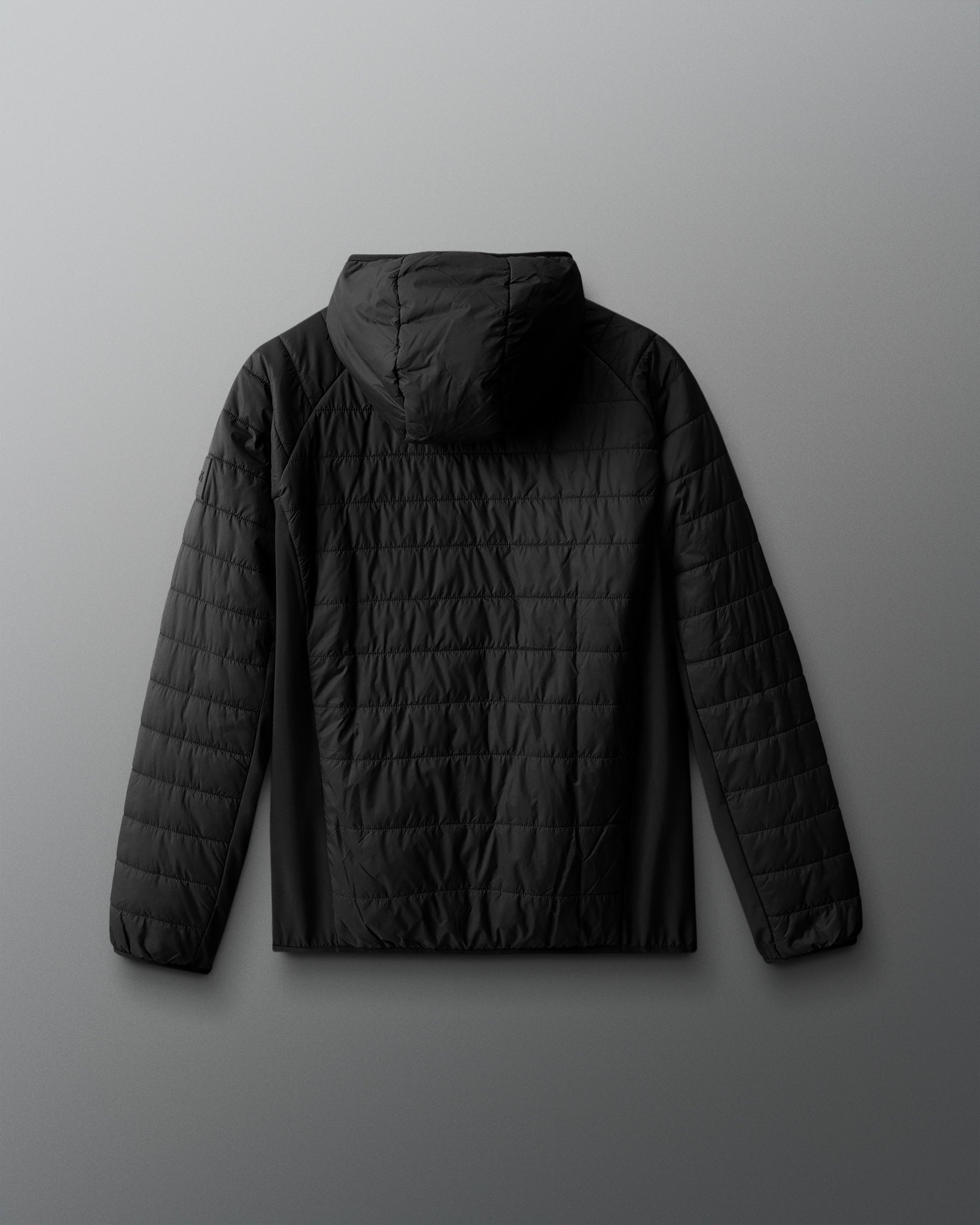 Black quilted jacket on a gray background