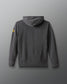 Gray hoodie with a yellow logo on the sleeve against a gray background