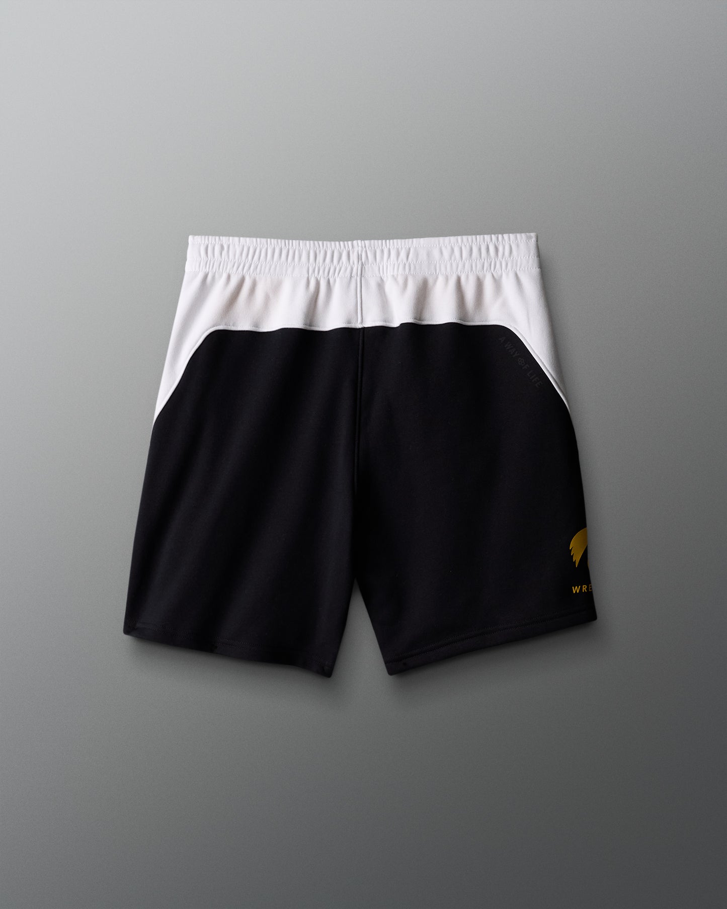Black shorts with a white waistband on a gray background