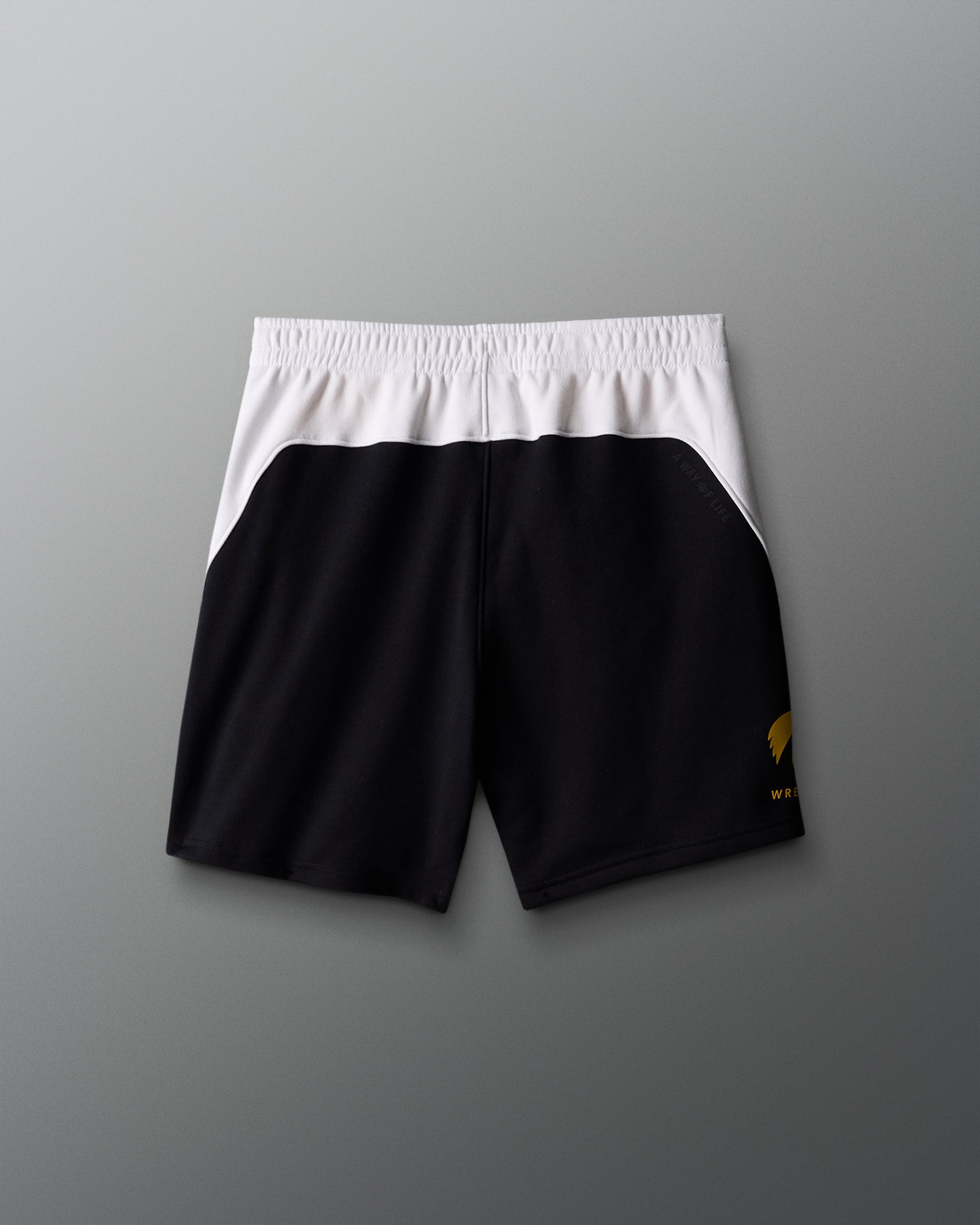 Black shorts with a white waistband on a gray background