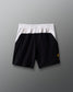 Black shorts with a white waistband on a gray background