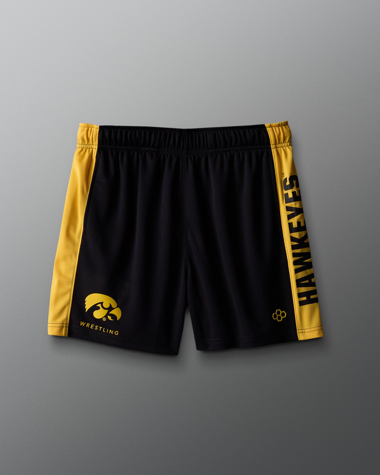 Black shorts with yellow accents featuring an Iowa logo on a gray background