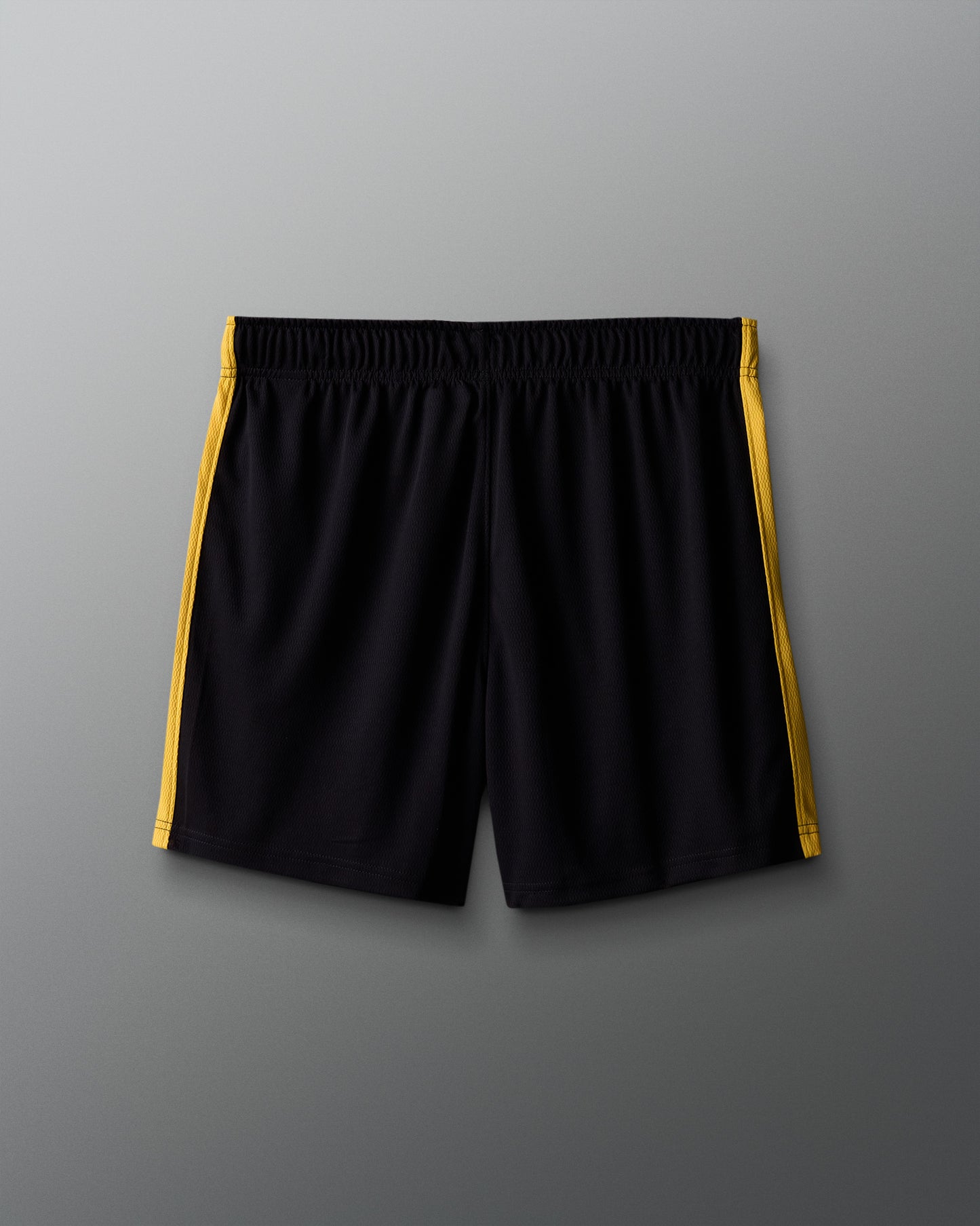 Black shorts with yellow stripes on a gray background
