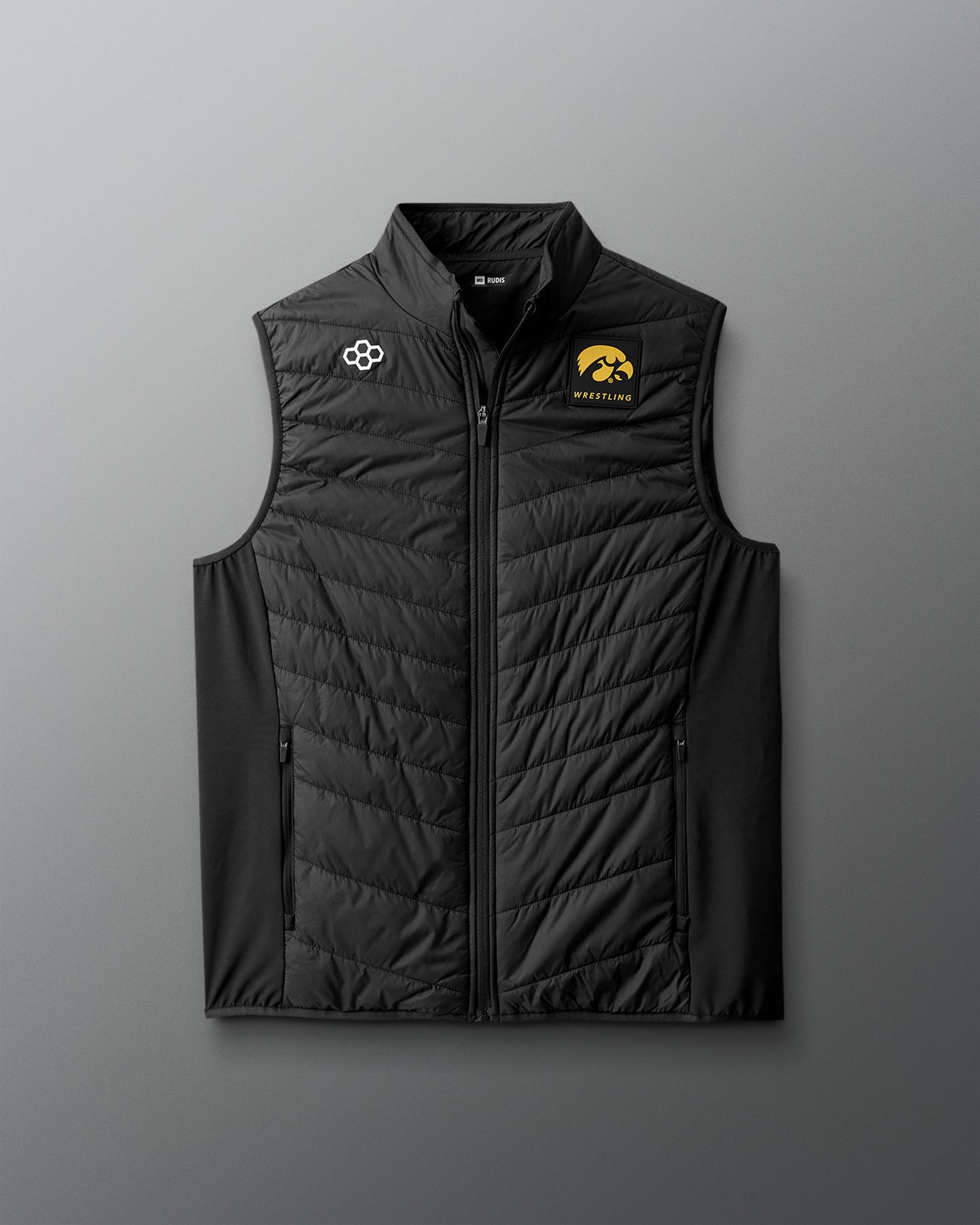 Black quilted vest with logos on a gray background