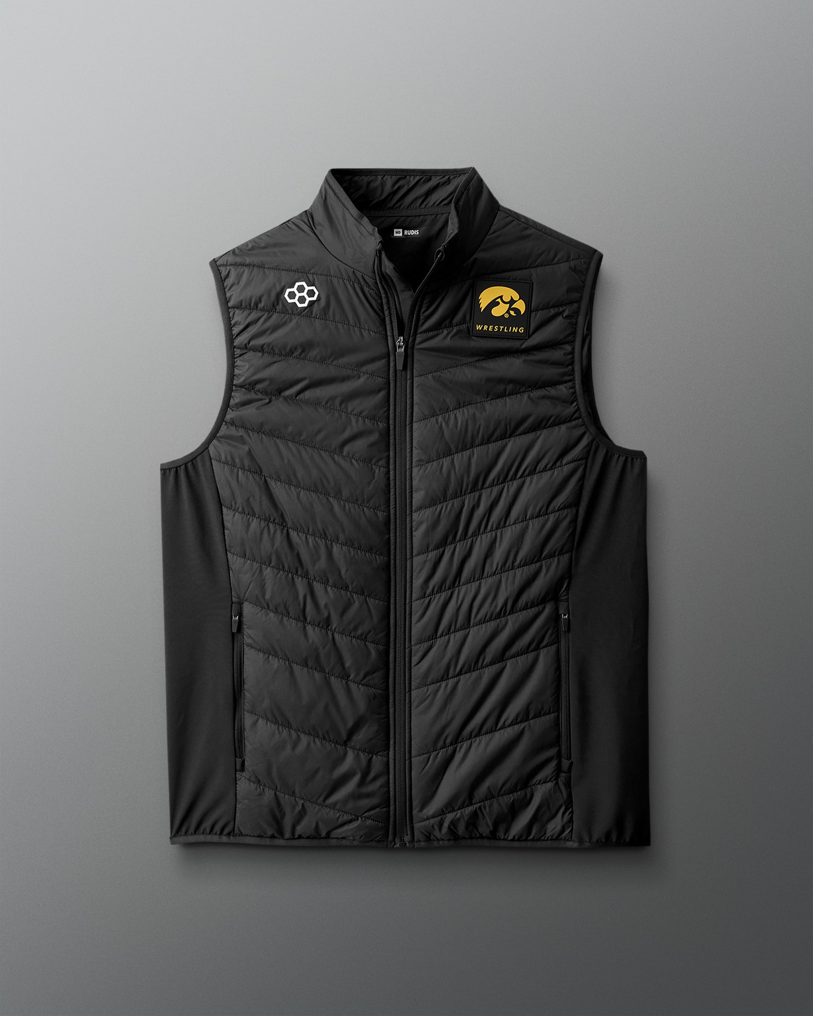 Black quilted vest with logos on a gray background