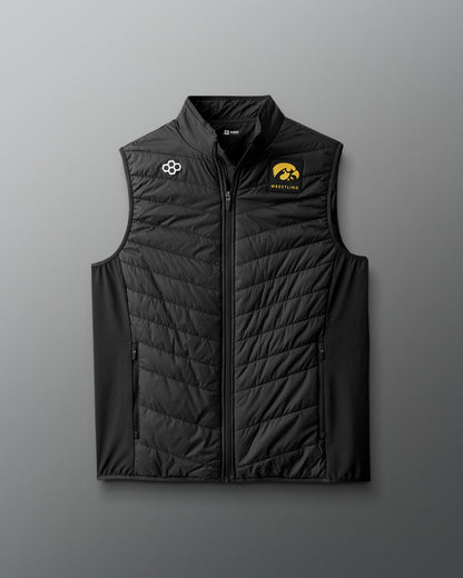 Black quilted vest with logos on a gray background