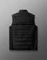 Black puffer vest on a light gray background
