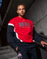 Person wearing a red and black Ohio State Wrestling sweatshirt sitting on steps.