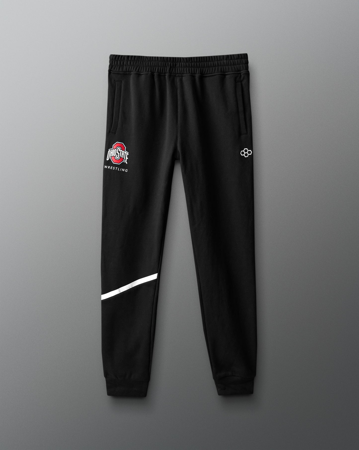 Black sweatpants with logos on a gray background