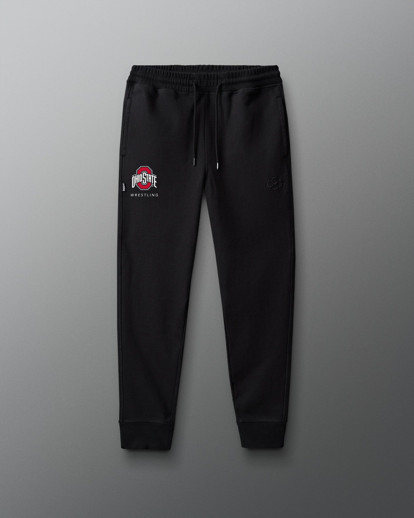 Black sweatpants with a logo on a gray background