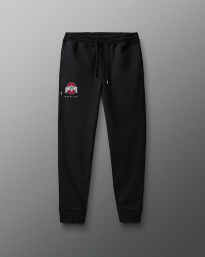 Black sweatpants with a logo on a gray background
