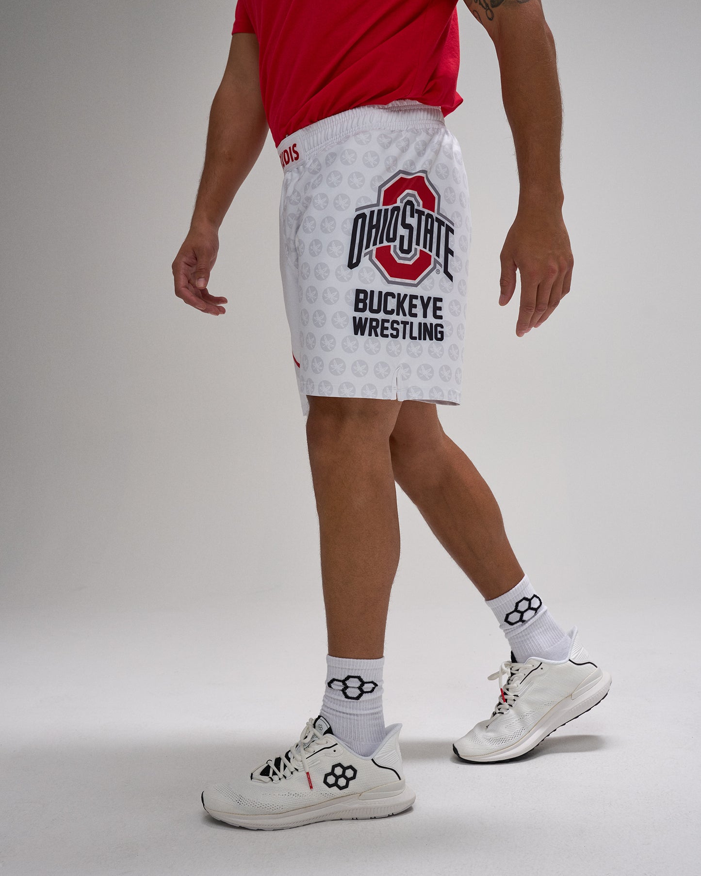 Person wearing Ohio State Buckeye Wrestling shorts on a gray background