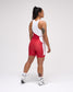 Person wearing a red and white wrestling singlet on a plain background