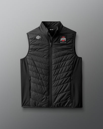 Black puffer vest with logos on a gray background