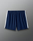 Navy blue shorts with white stripes on a gray background