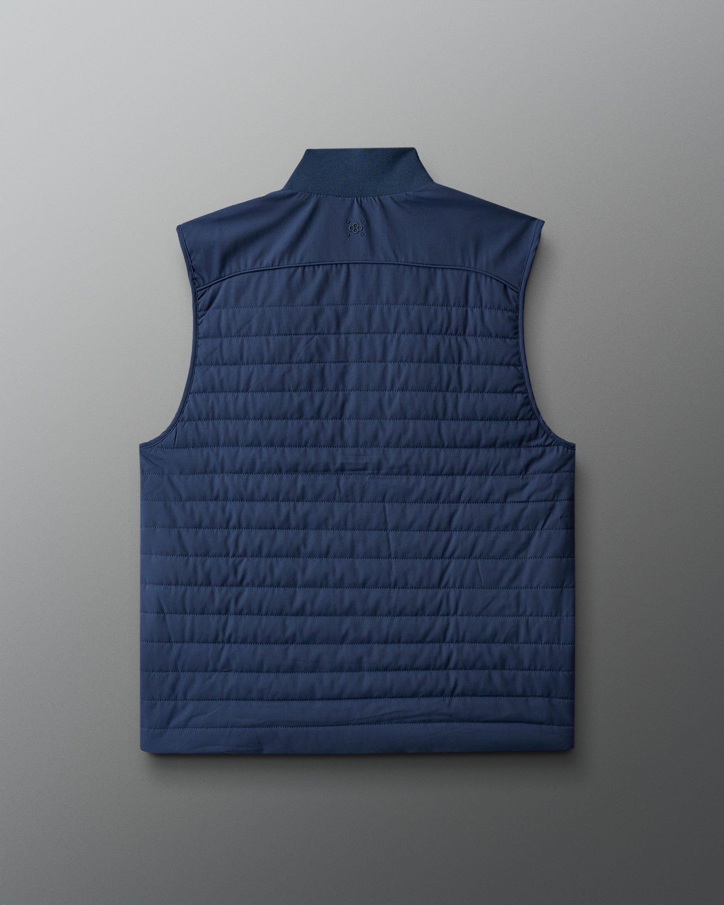 Blue quilted vest on a light gray background