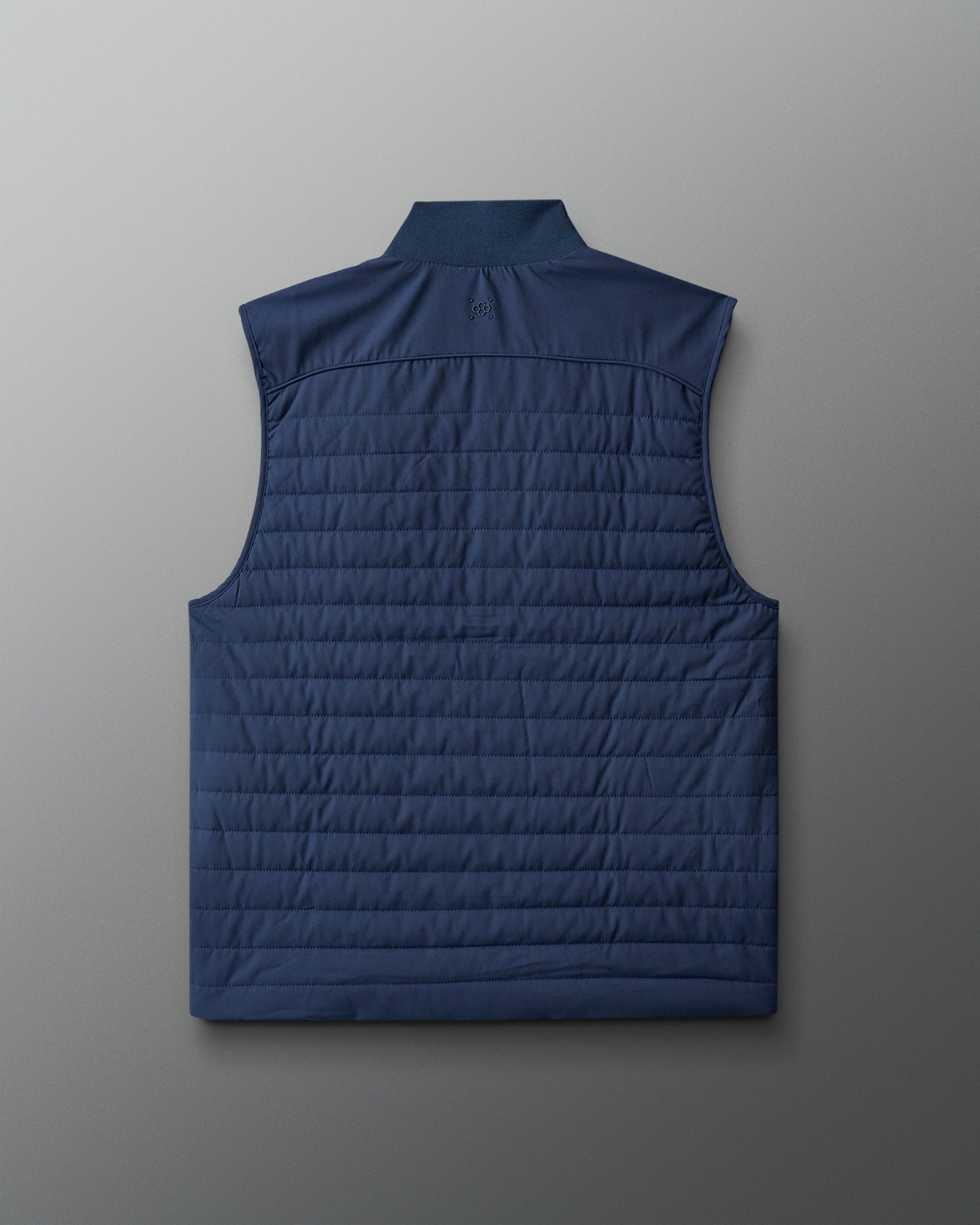 Blue quilted vest on a light gray background