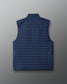 Blue quilted vest on a light gray background