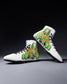 White wrestling shoes with green and orange pattern on a gray background