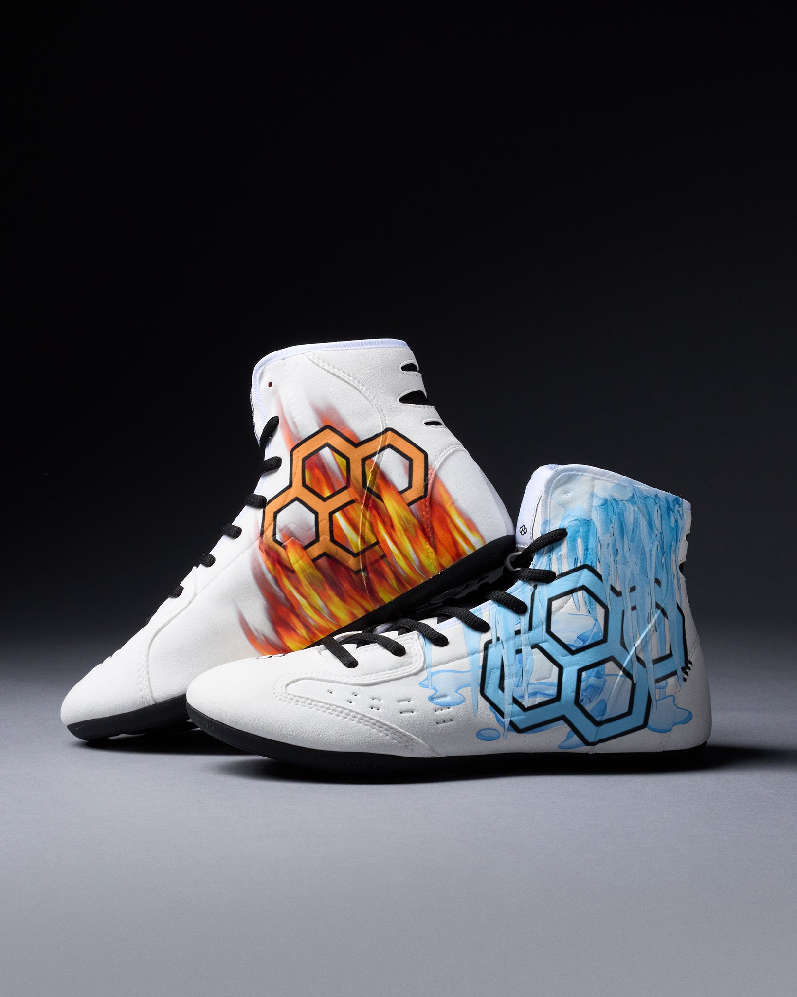 White wrestling shoes with colorful designs on a gray background