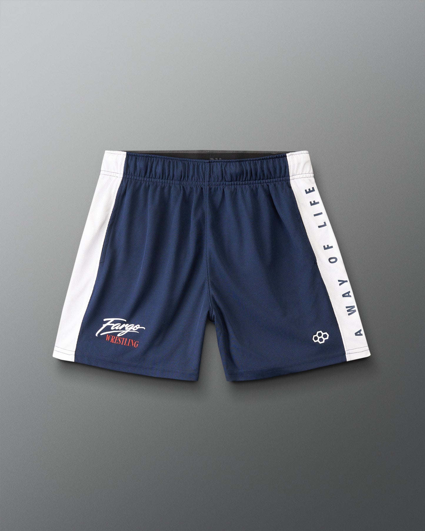 A pair of navy blue athletic shorts with white side panels and white text reading 'A WAY OF LIFE' down one leg, laid flat on a gray background.