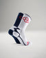 A pair of athletic socks features a contrasting navy blue and white design with red accents highlighting breathable materials for optimal performance